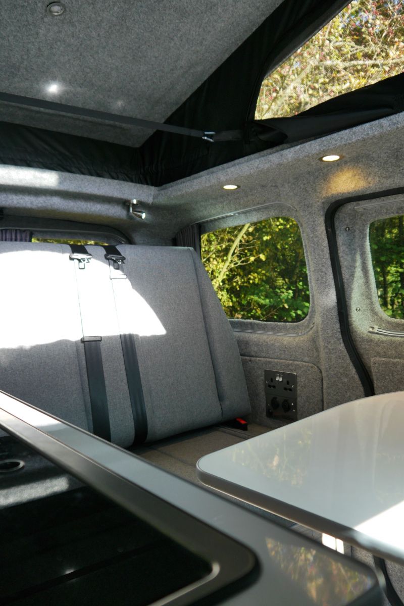 Silver NV200 CamperCar grey seats Sussex Campervans kitchen to rnr bed seat.JPG