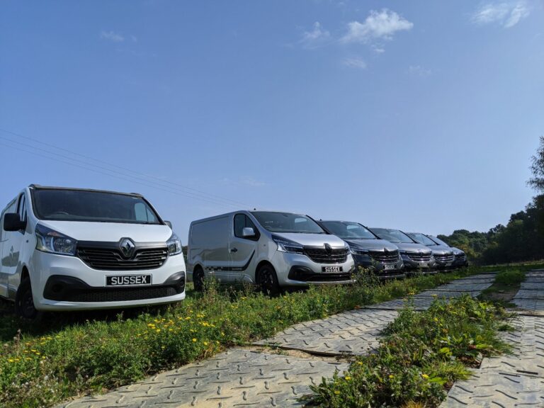 different models of campervans parked in the field