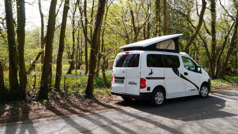 white campervan parked beside the road